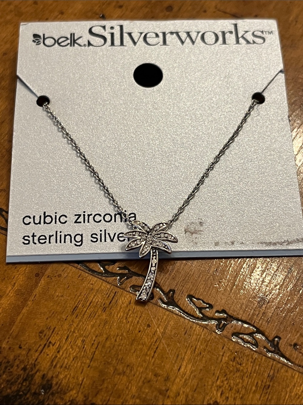 Sterling silver palm tree pendant on silver toned chain